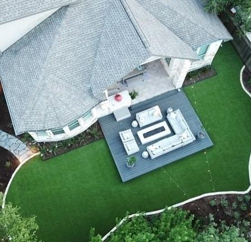 Aerial view of a composite deck and flagstone patio on a Bee Cave property