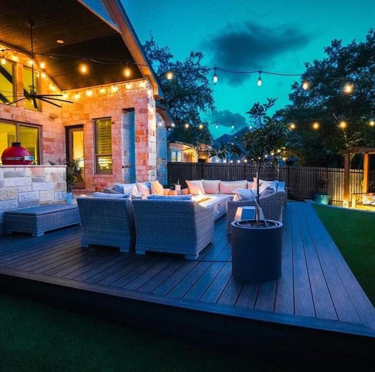 Low-voltage landscape lighting on an Austin deck and pergola at night