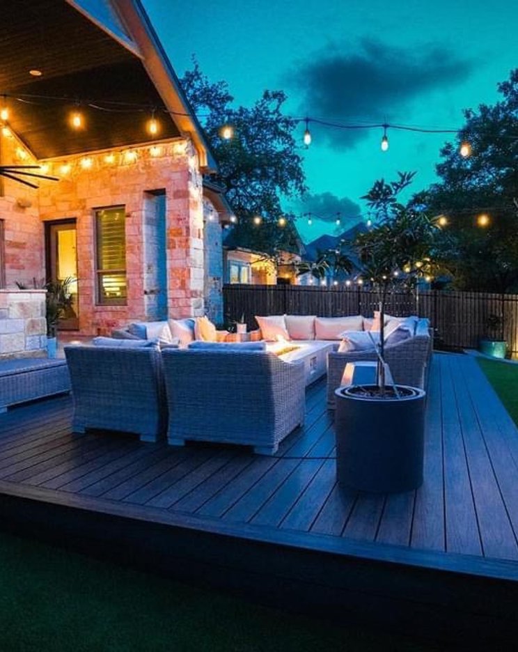 Bee Cave backyard washed with warm landscape lighting at night