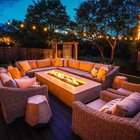 Bee Cave backyard at night with a lit fire pit, string lights over the deck, and cedar privacy screens washed with low voltage landscape lighting
