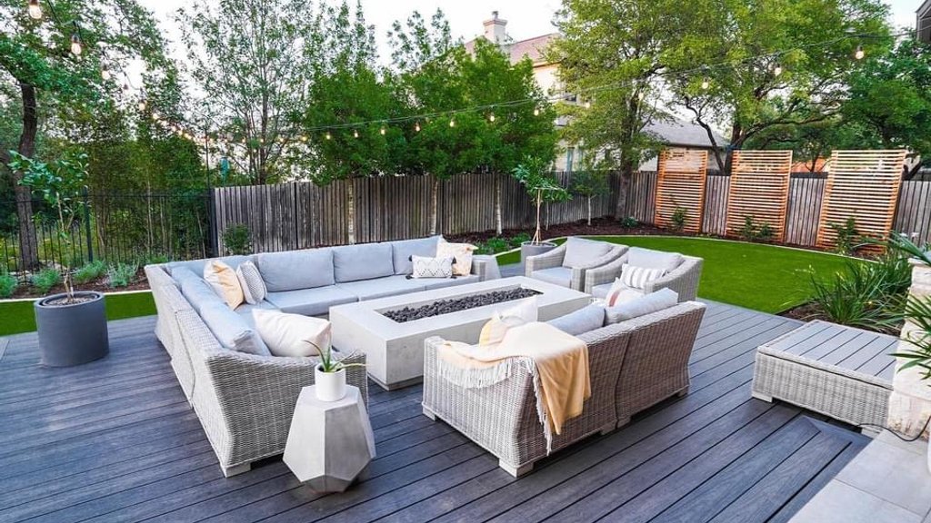 Composite deck boards with a clean surface beside a firepit and turf in Bee Cave