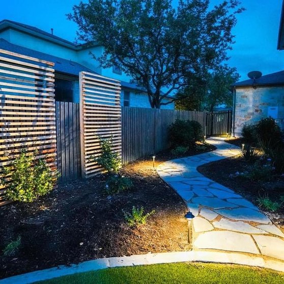 Path lights along a flagstone walkway in a Bee Cave backyard