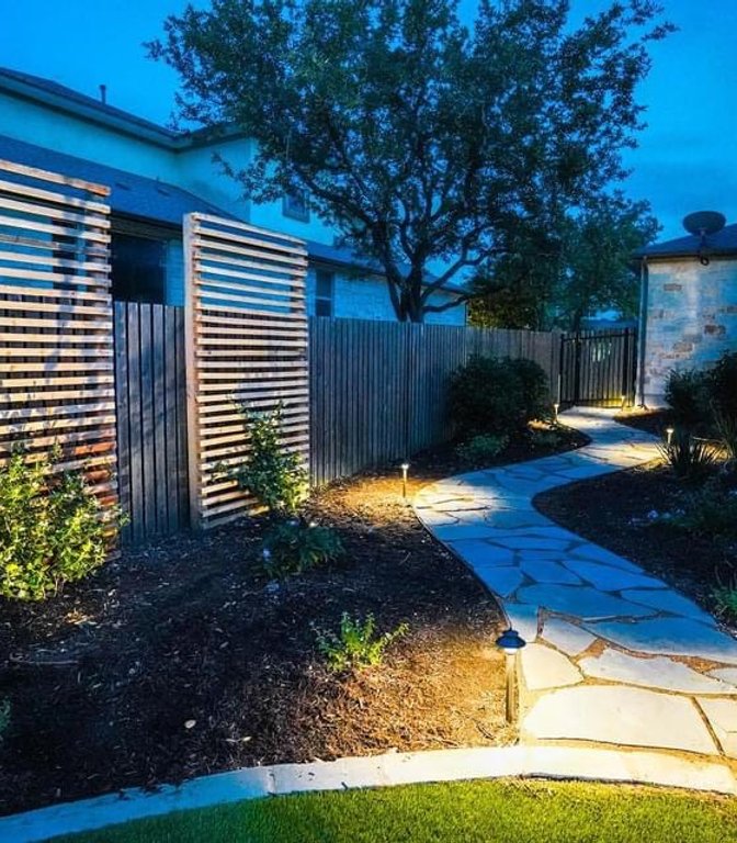 Path lighting along a flagstone walkway in a Bee Cave backyard