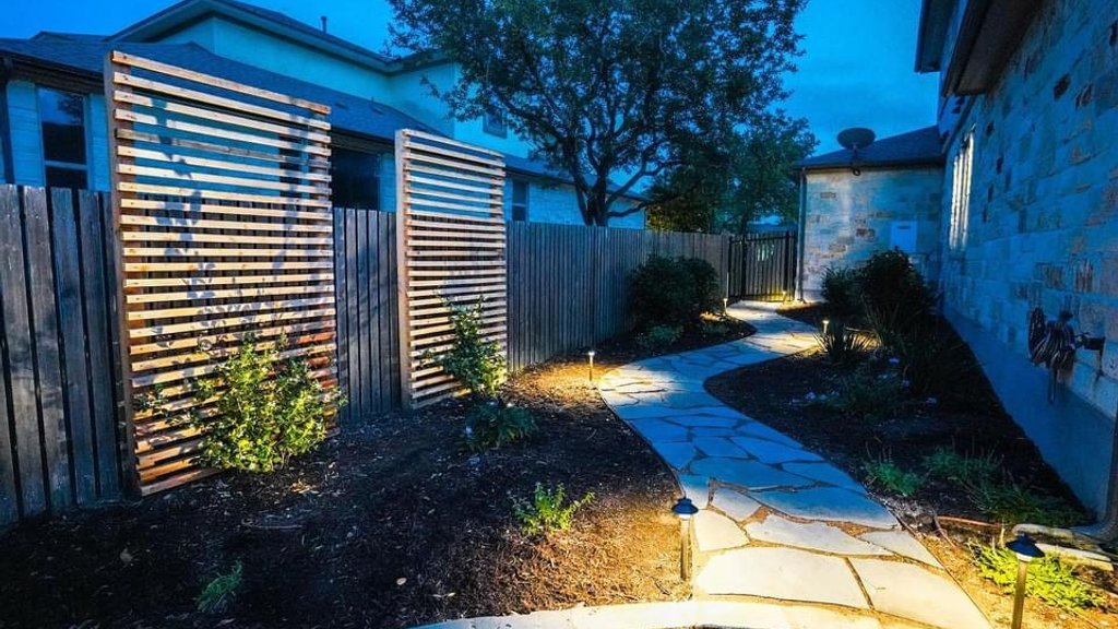 Path lights aimed and programmed along a finished flagstone walkway in Bee Cave