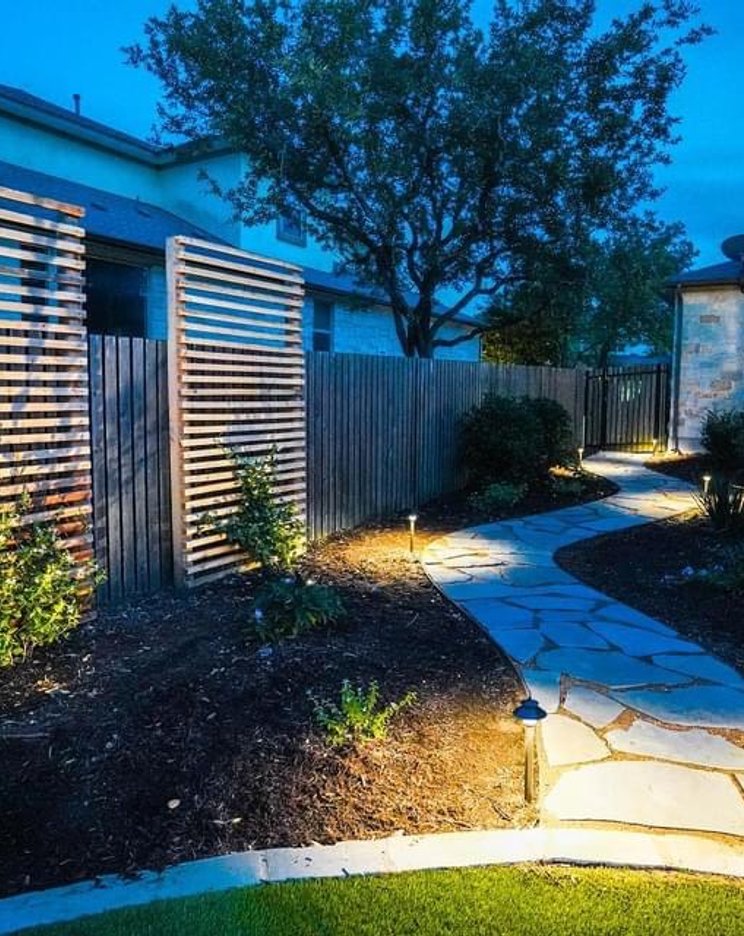 Bee Cave backyard with low-voltage path and accent lighting along a flagstone walkway
