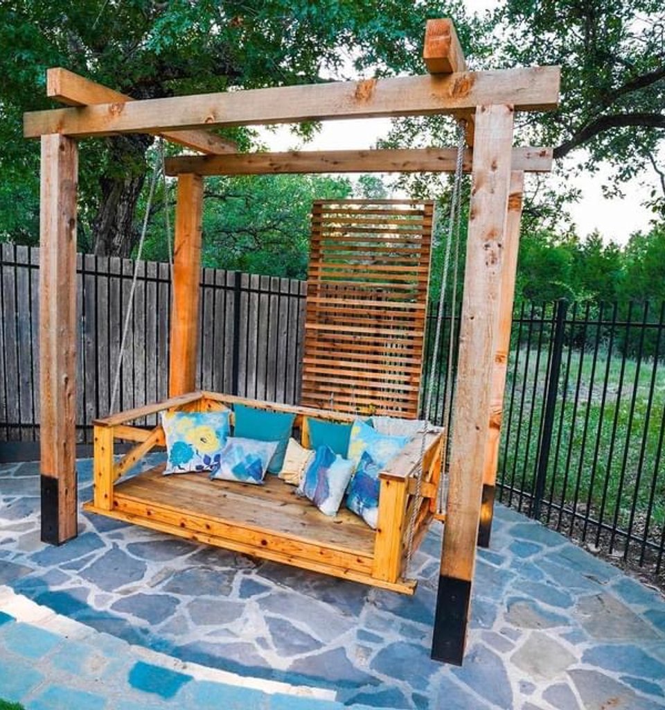 Bee Cave backyard pergola with a hanging swing over a flagstone patio