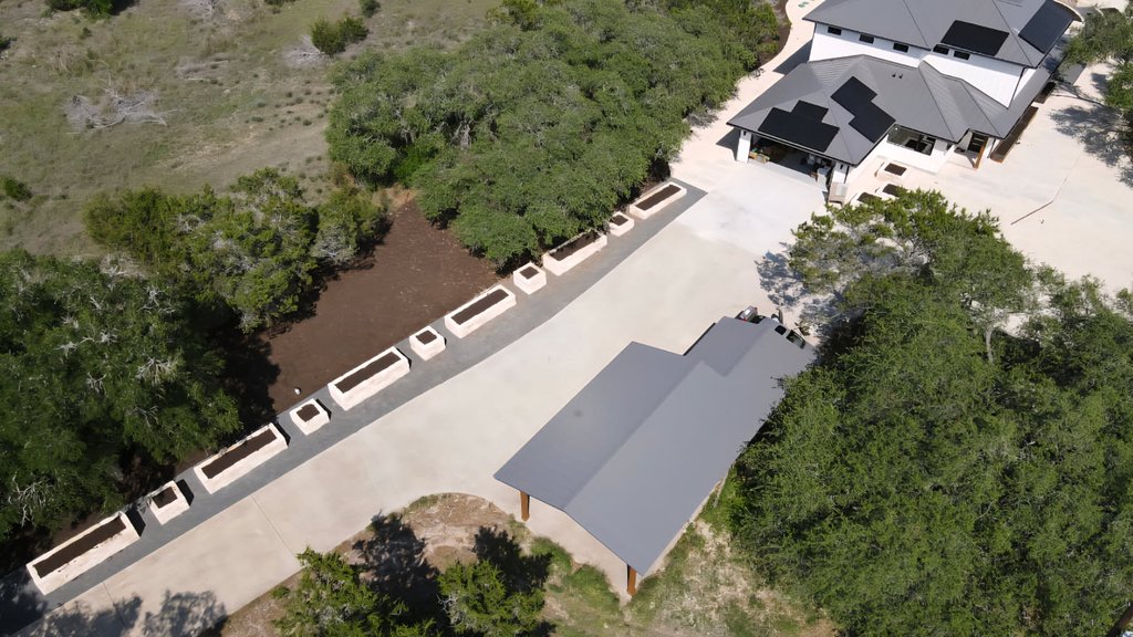 Aerial view of a Driftwood yard during assessment, showing grade and drainage layout around the driveway
