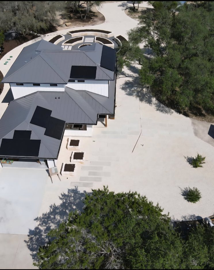 Aerial view of stone-framed raised garden beds at a Driftwood home