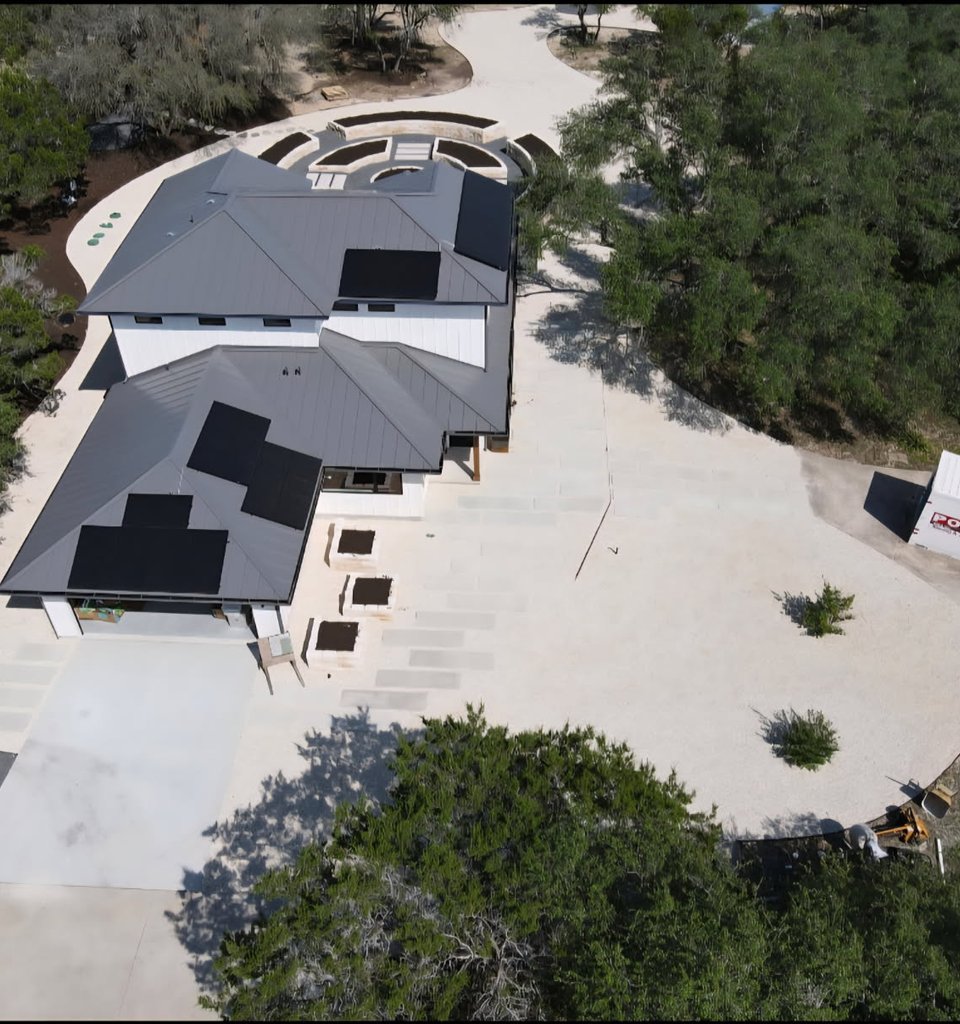 Driftwood garden estate with raised limestone beds and a formal circular garden