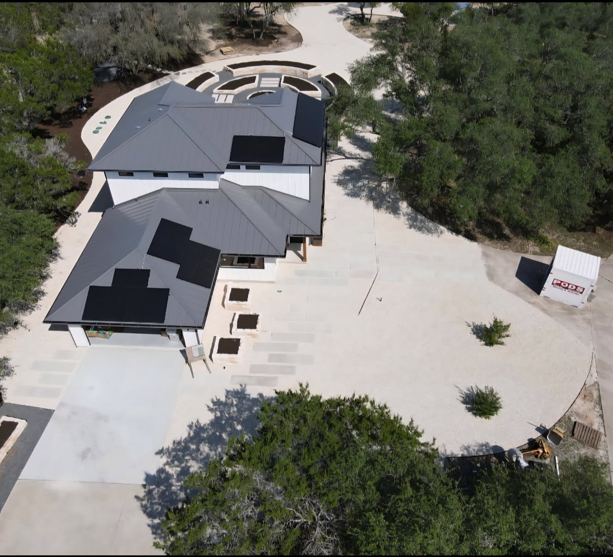 Driftwood garden estate with raised limestone beds and a formal circular garden