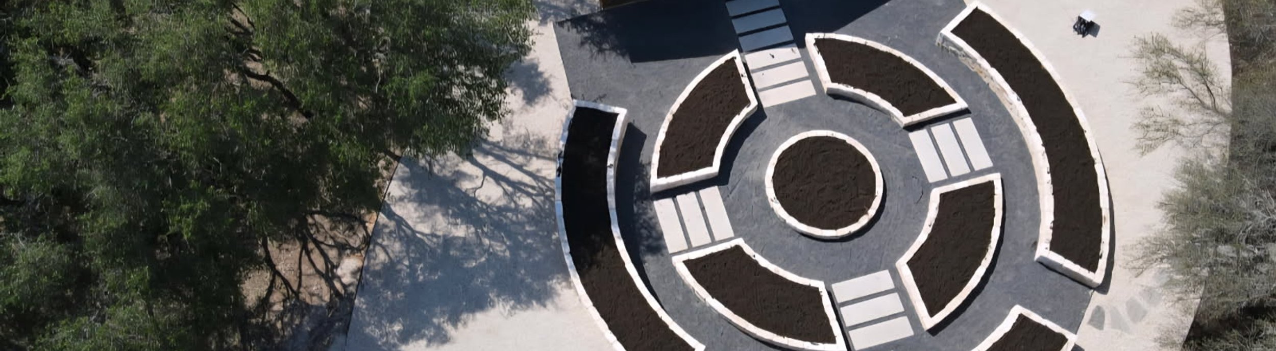 Aerial view of a Driftwood, TX garden estate with raised beds and paver pathways by Thrive Landscape and Design