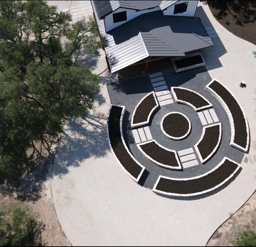 Aerial view of a leveled Driftwood yard with raised beds and a paver path laid out for drainage