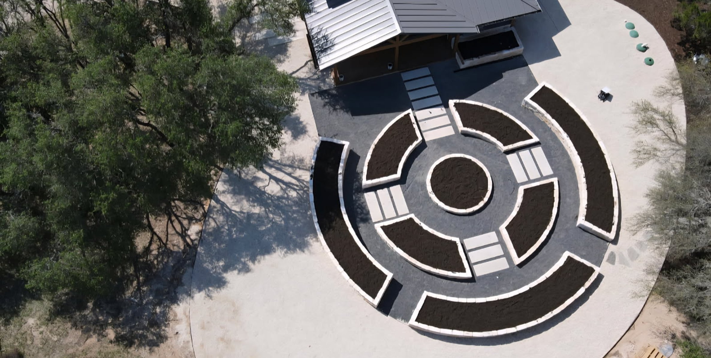 Aerial view of the formal circular mandala garden built from concentric limestone raised beds