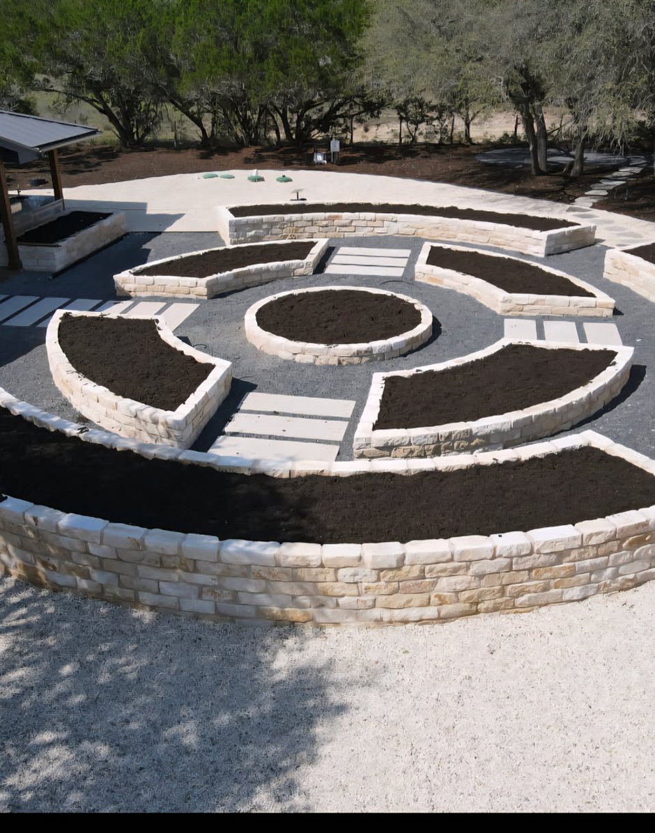 Flagstone pathway dividing the limestone raised beds