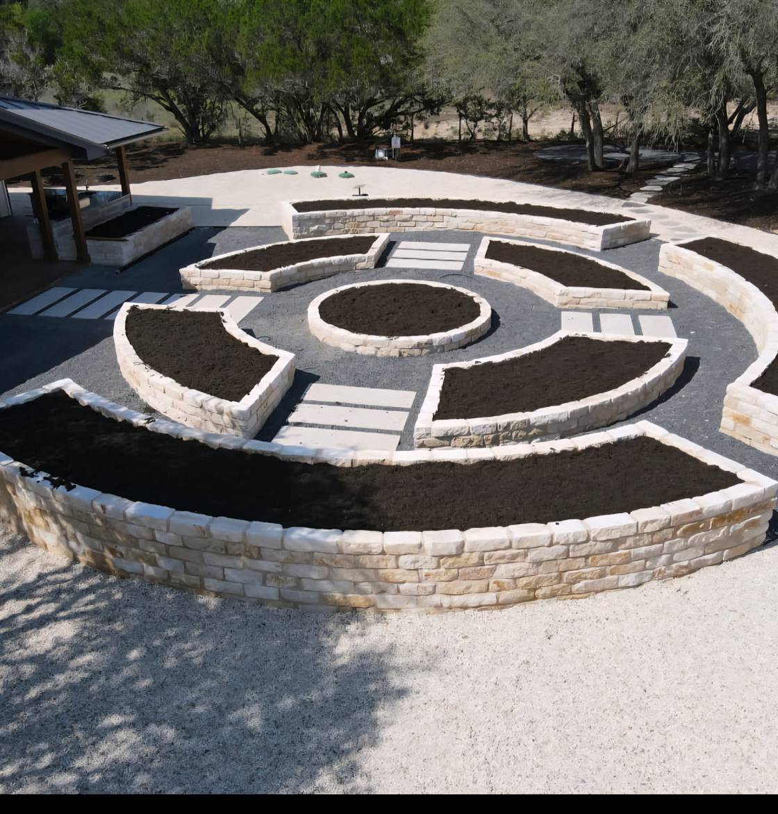 Driftwood home with stone walkway, native plantings, and landscape lighting