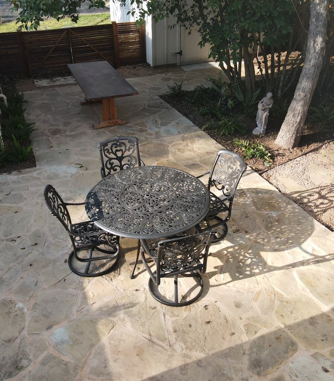 Wood fence behind a flagstone patio and fountain on a Fayetteville property