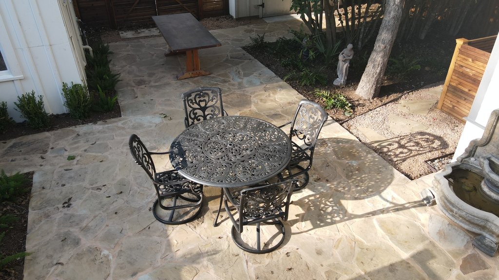 Custom wood fence after stain and seal behind a flagstone patio in Fayetteville