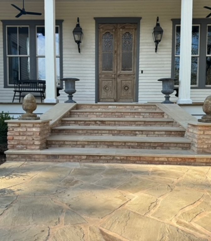 Refreshed front yard with a flagstone walkway and brick steps in Fayetteville