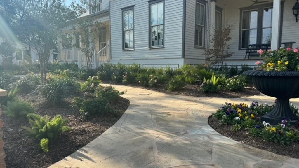 Flagstone walkway and garden beds audited for path lighting on a Fayetteville property