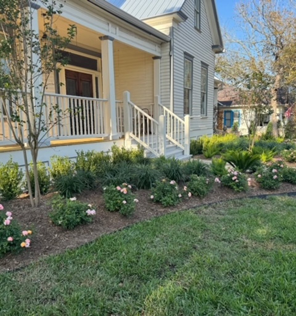 Fayetteville garden-district beds freshly mulched alongside a green lawn