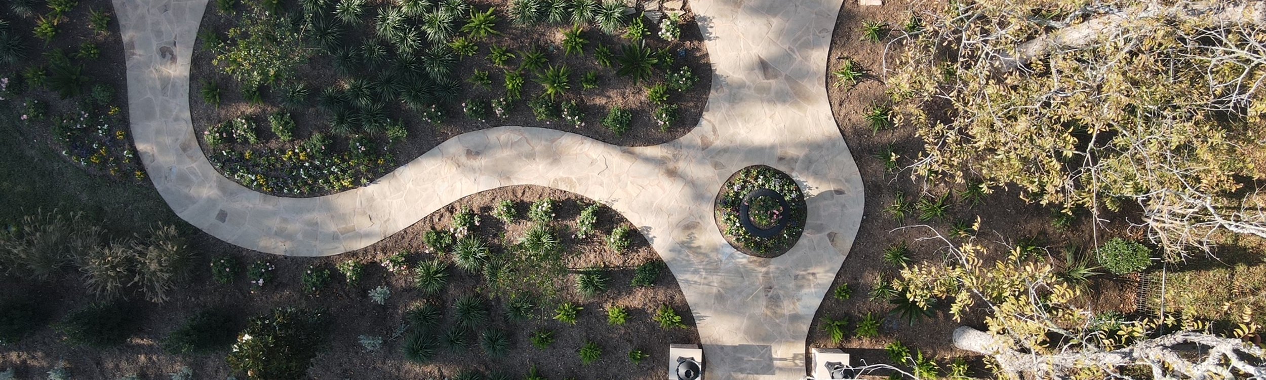 Aerial view of layered garden beds and a walkway in a Fayetteville garden near Austin