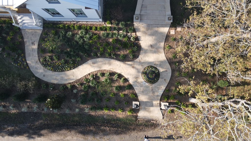Aerial view of a flagstone walkway laid out through garden beds at a Fayetteville home