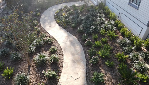 Designed walkway and layered garden beds at a renovated Fayetteville-area landscape