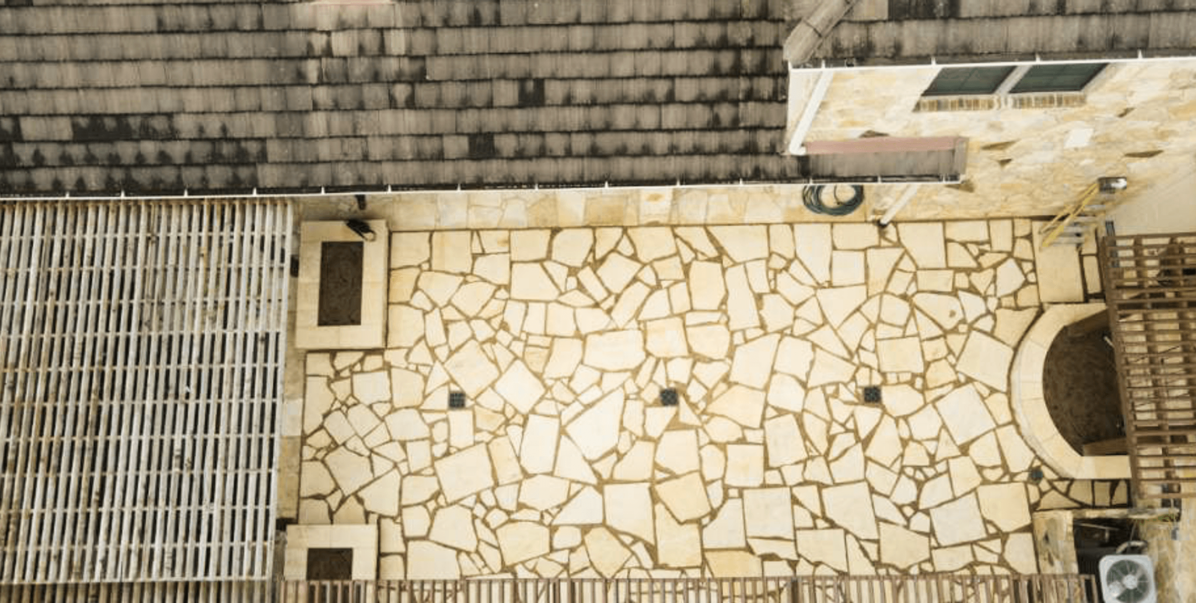 Aerial view of the flagstone patio and pergola spanning the entertaining area