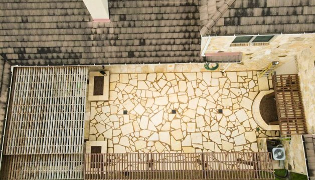 Aerial of a Lakeway flagstone patio with pergola and trellis