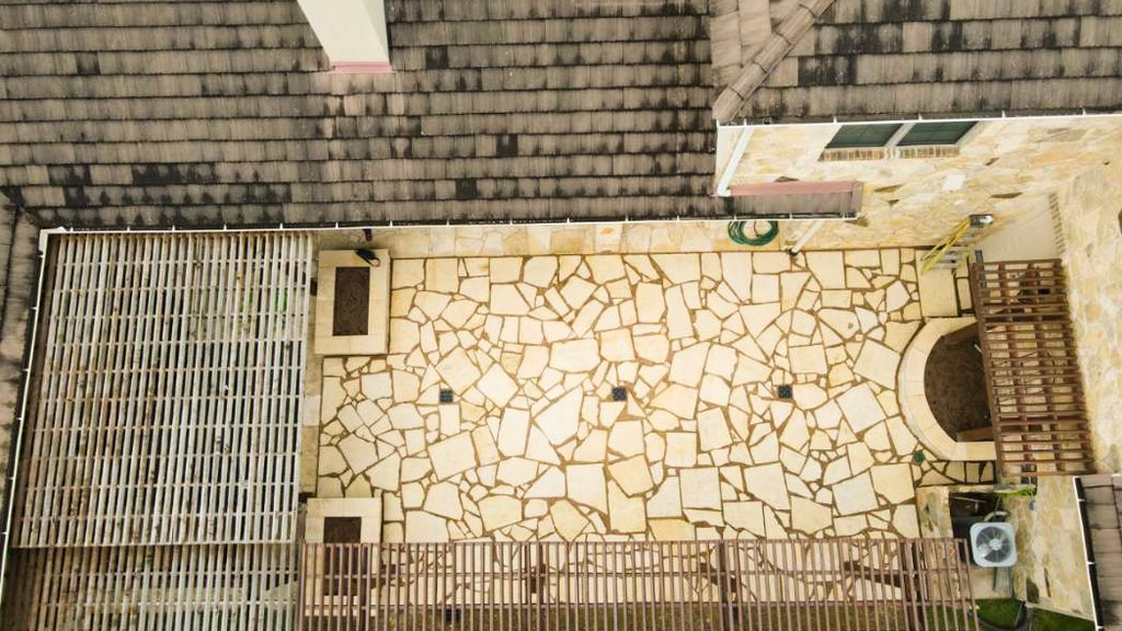 Aerial view of a flagstone patio laid out with a pergola and trellis at a Lakeway home