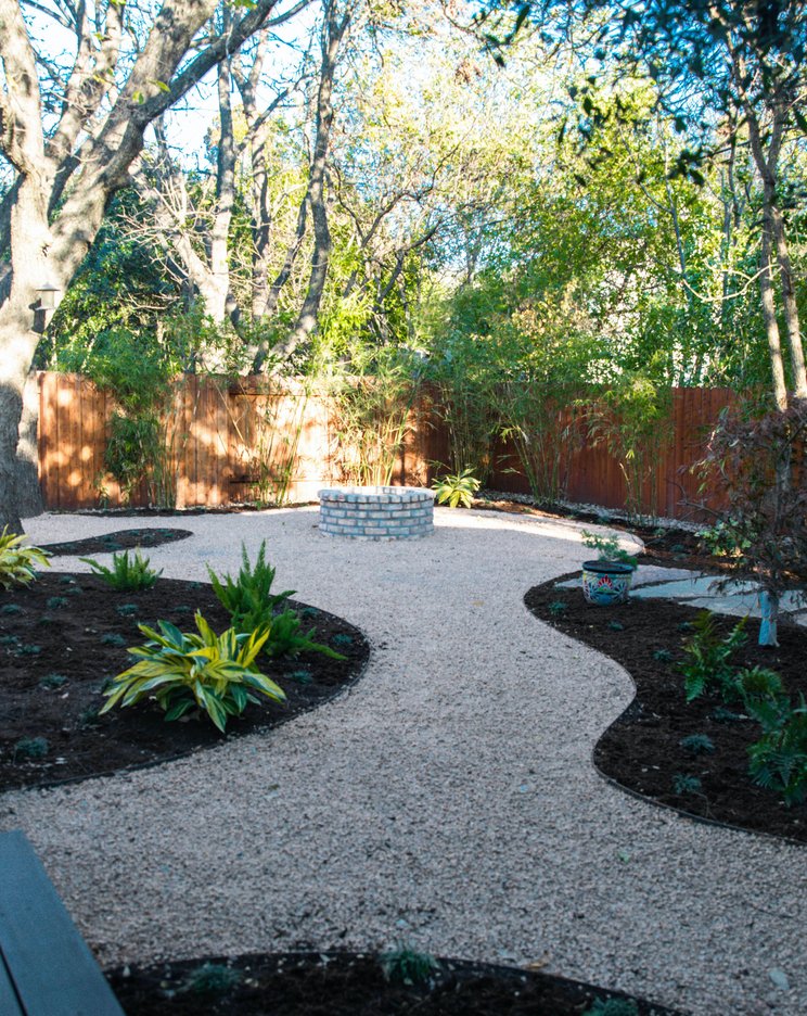 Composite deck with a firepit and clean board surface in a shaded Riverplace garden