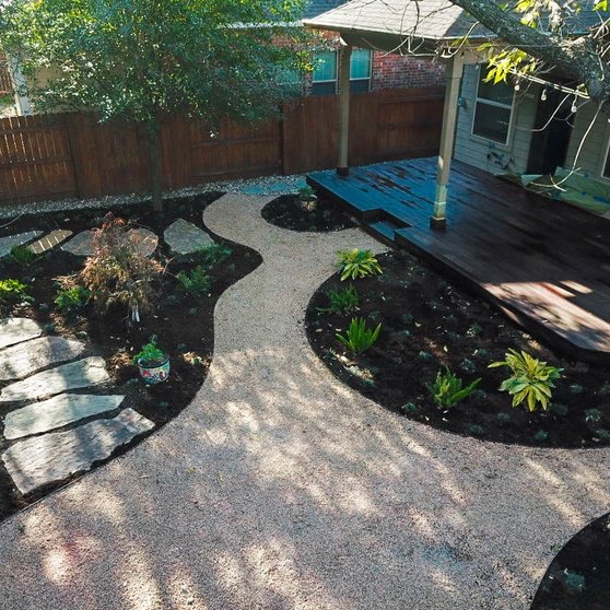 Custom deck with a flagstone pathway in a shaded Riverplace garden