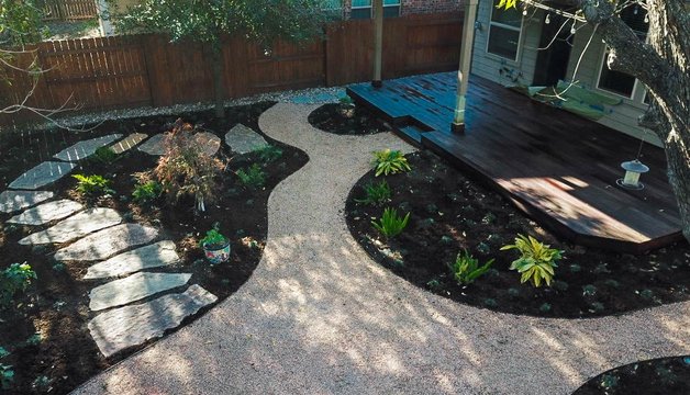 Mulched and decomposed-granite planting beds along a Riverplace garden pathway
