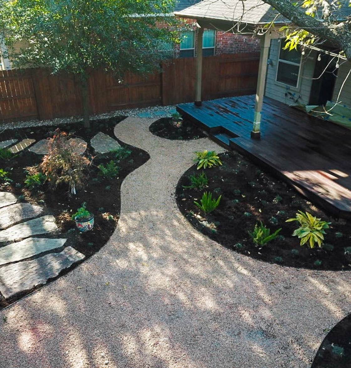 River Place home with stone walkway, native plantings, and landscape lighting