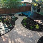 Austin backyard in the River Place neighborhood with a flagstone pathway, decomposed granite, a fire pit, and native planting beds