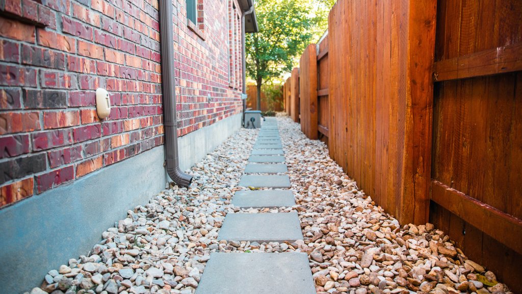 Stepping stones set into a compacted base along a river rock side-yard path in Riverplace