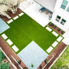 Aerial view of a Round Rock backyard with an artificial turf panel, stepping stones, gravel, and planting beds replacing a struggling lawn