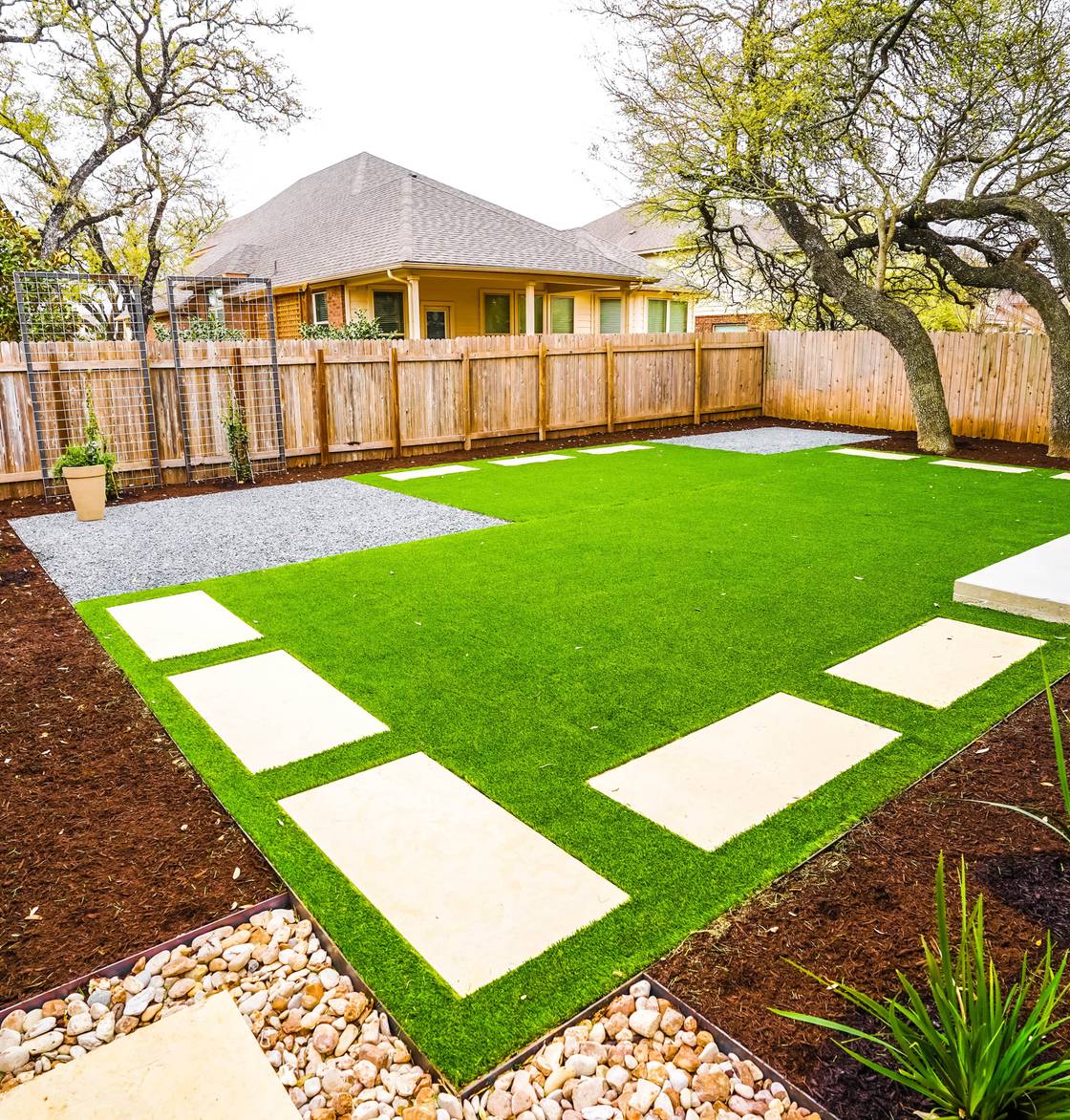 Round Rock home with stone walkway, native plantings, and landscape lighting