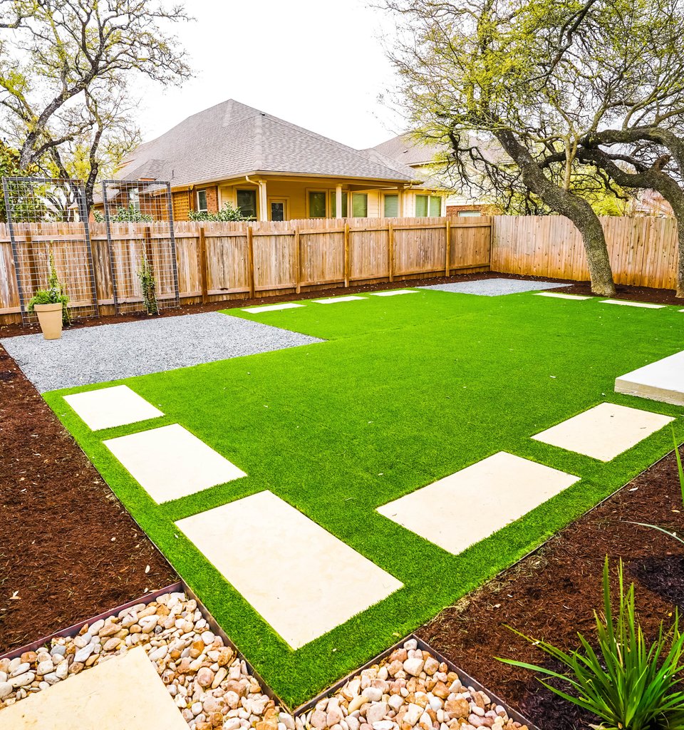 Round Rock lawn with turf, stepping stones, gravel, and river-rock beds