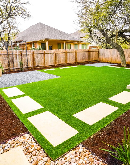 Round Rock home entry with native plants and walkway lighting