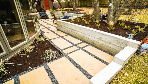 Gravel drainage path beside a graded planting bed in a Shoal Creek backyard