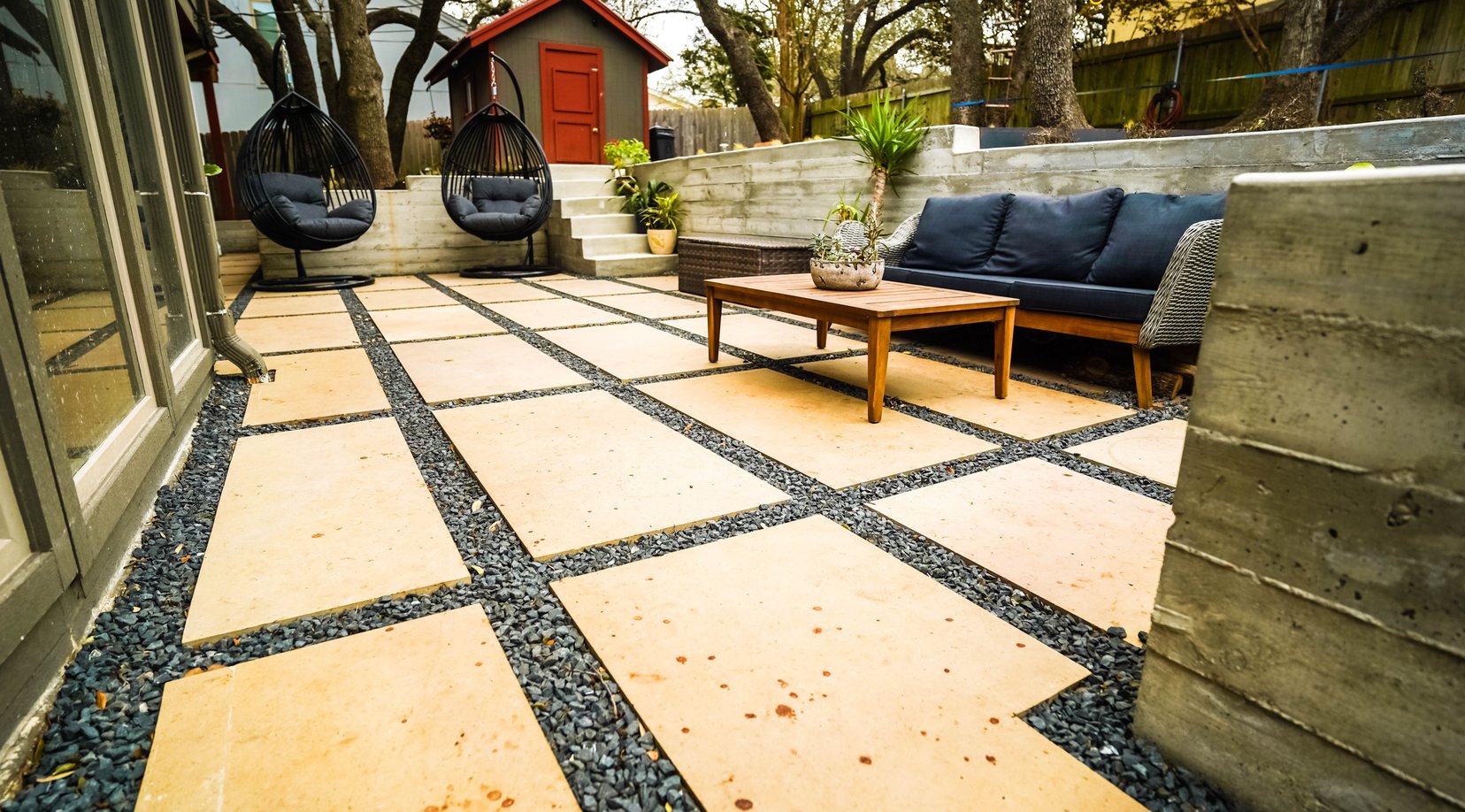 Concrete terrace steps and paver patio with ornamental grasses