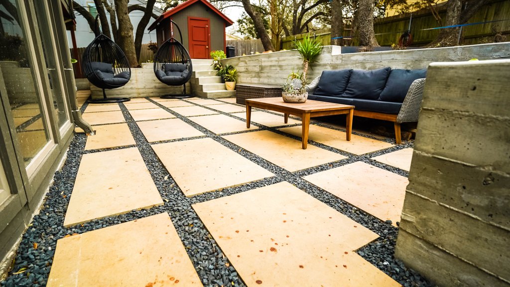Compacted gravel base and concrete retaining wall steps prepared for a Shoal Creek patio