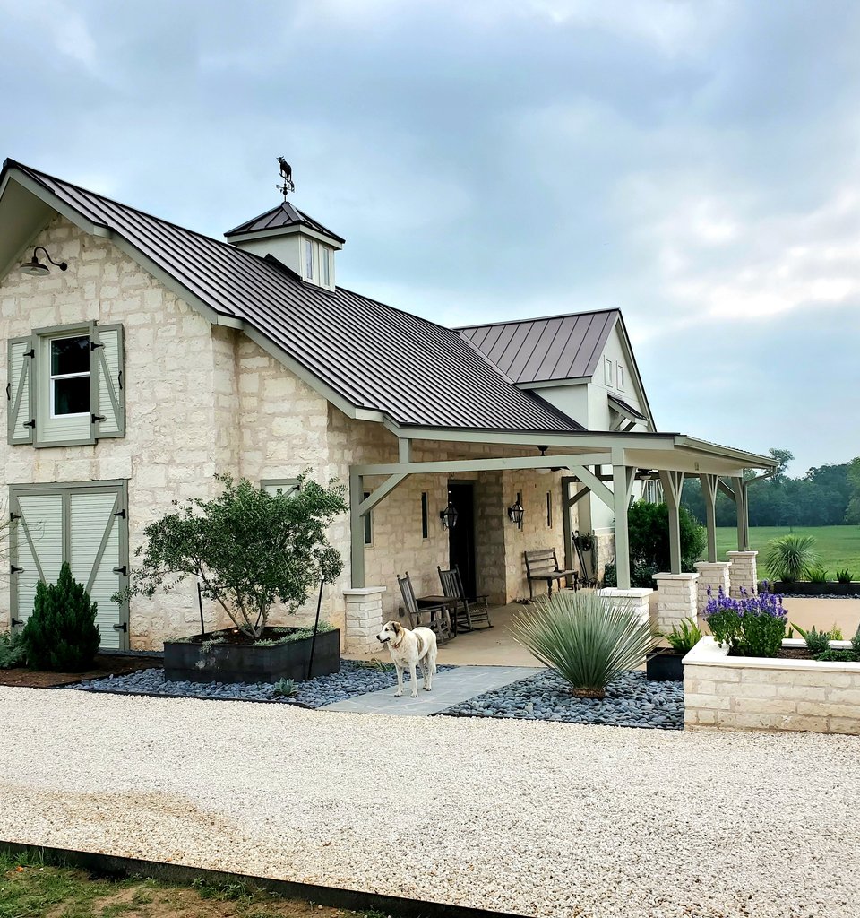 Smithville ranch home with a long crushed-stone driveway and stone planter beds