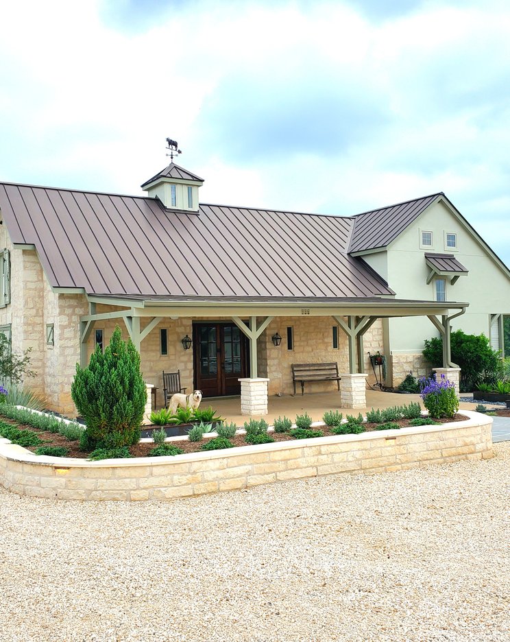 Natural limestone retaining walls forming planter beds at a Central Texas home