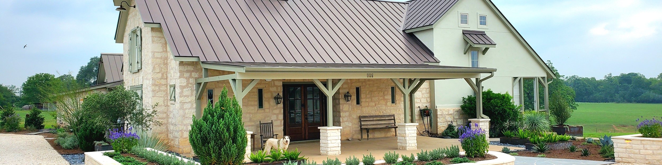 Smithville ranch home with stacked stone retaining walls and landscaped planter beds
