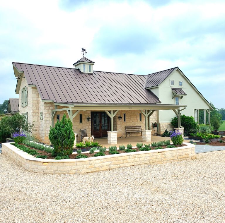 Stone retaining walls and planter beds at a Smithville-Ranch home landscape installation