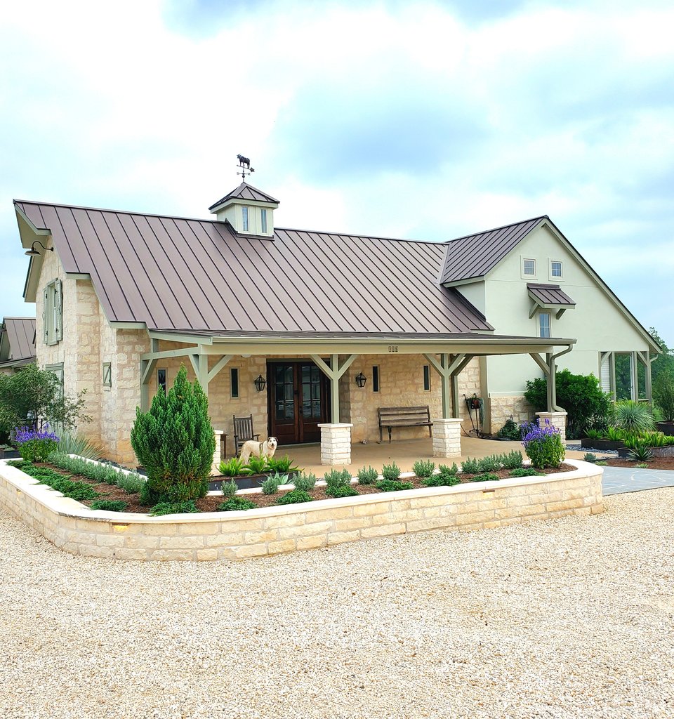 Smithville ranch landscape with limestone retaining wall and native plantings
