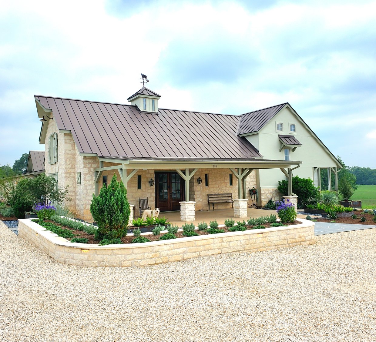 Smithville ranch landscape with limestone retaining wall and native plantings