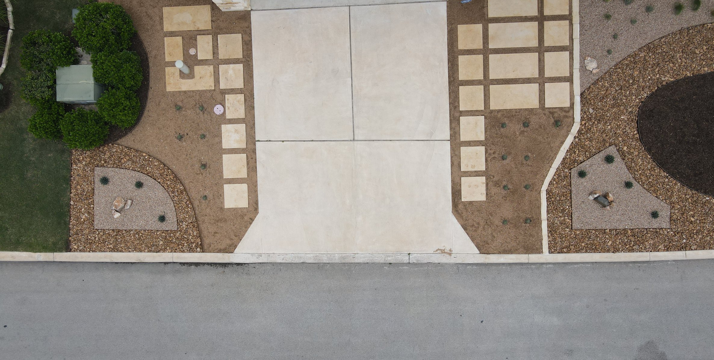 Aerial view of the driveway flanked by cream paver grids in decomposed granite